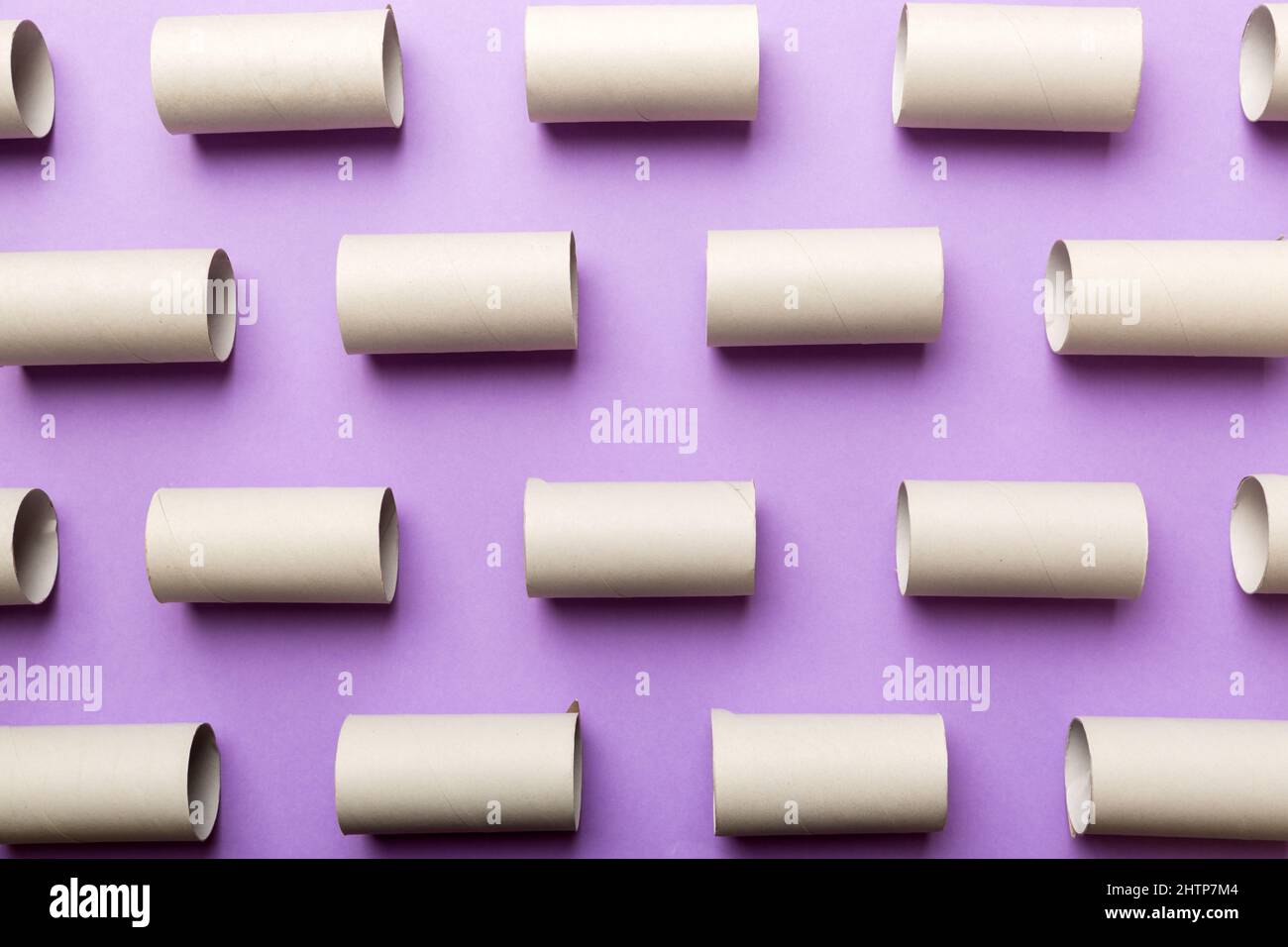Empty toilet paper roll on colored background. Recyclable paper tube