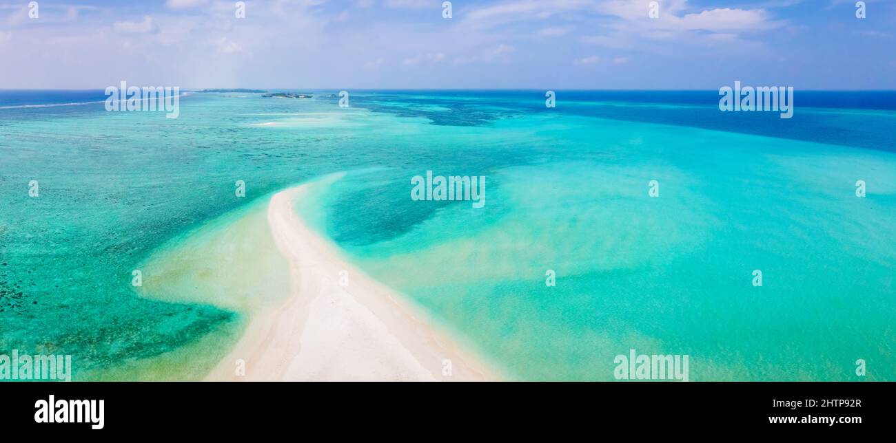 Sandbank beach for holidays vacation with white sand and turquoise blue transparent water. Aerial view from drone. Pristine tropical atoll island in M Stock Photo
