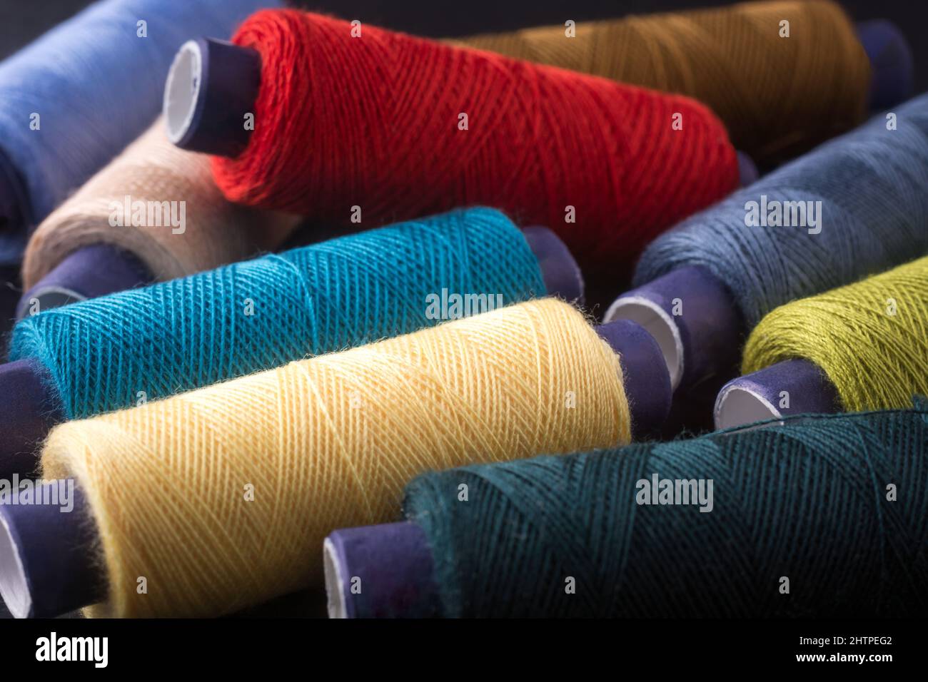 spool of sewing thread used in fabric and textile industry, different