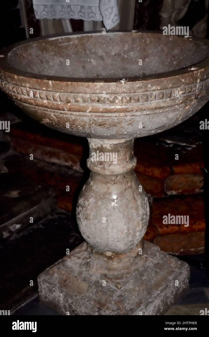 Baptismal font in the christian church. Baptismal font made of stone in