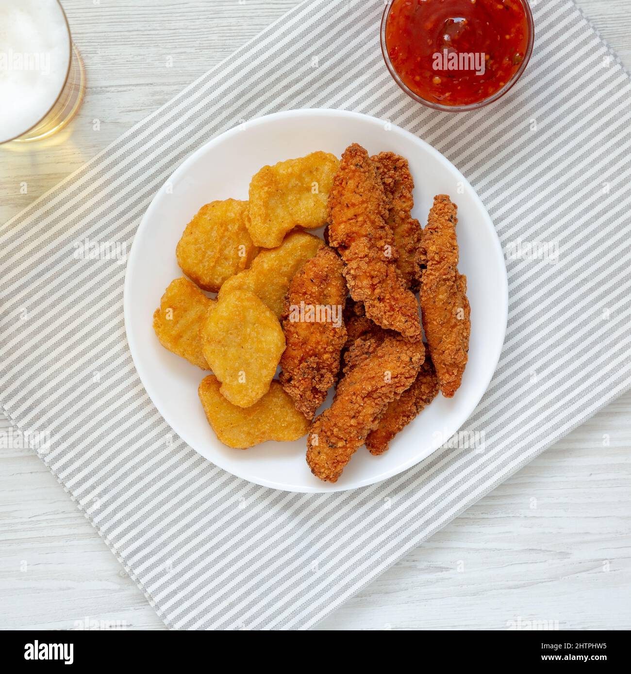 Homemade Nuggets and Chicken Tenders with Sauce and Beer, top view. Overhead, from above, flat