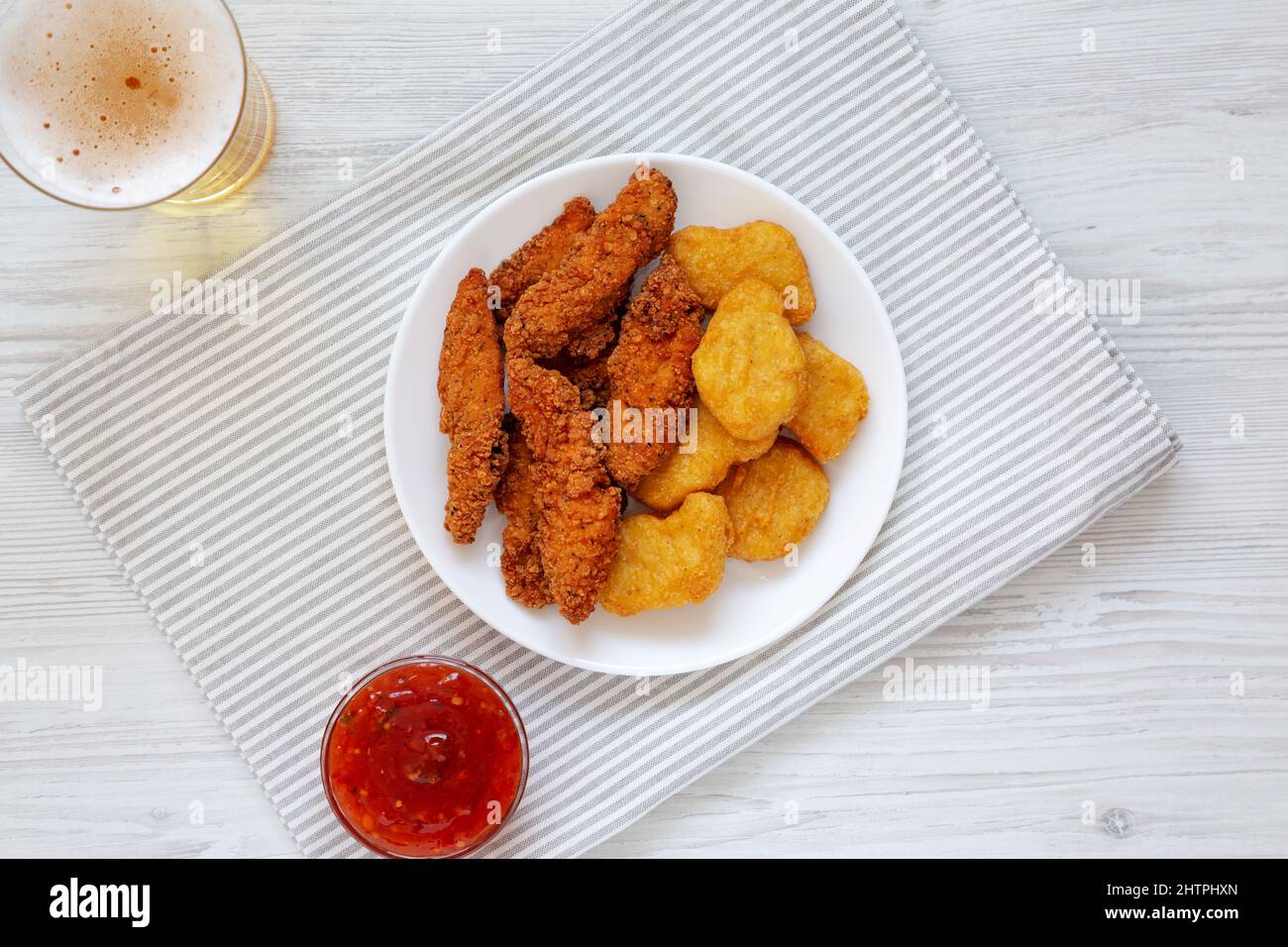 Homemade Nuggets and Chicken Tenders with Sauce and Beer, overhead view