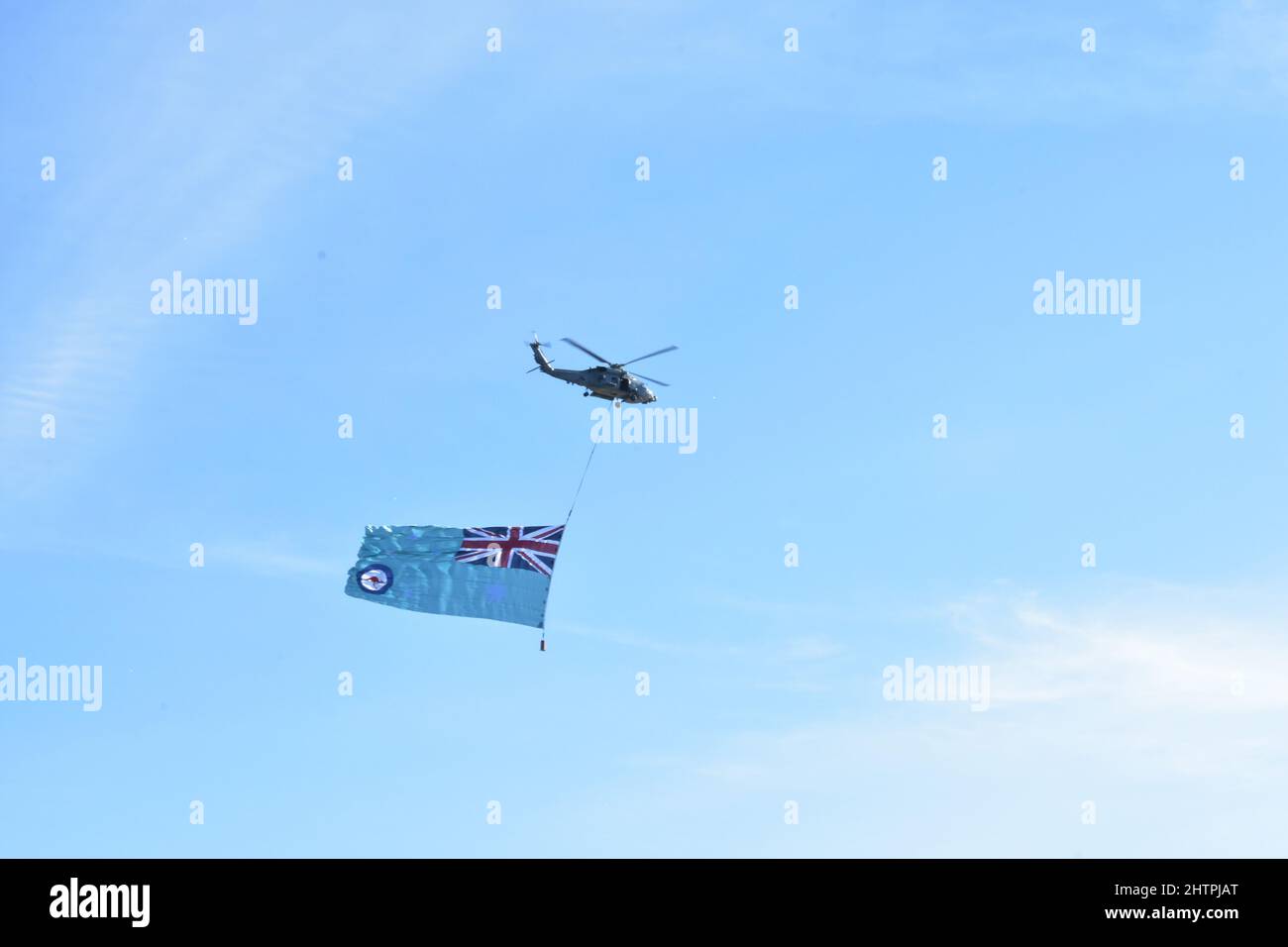 A Royal Australian Navy helicopter carrying a large Royal Australian ...