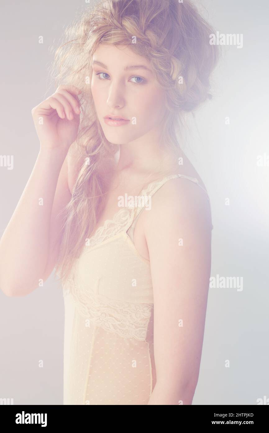 Classic beauty. Pretty model looking at the camera with a plait in her hair. Stock Photo