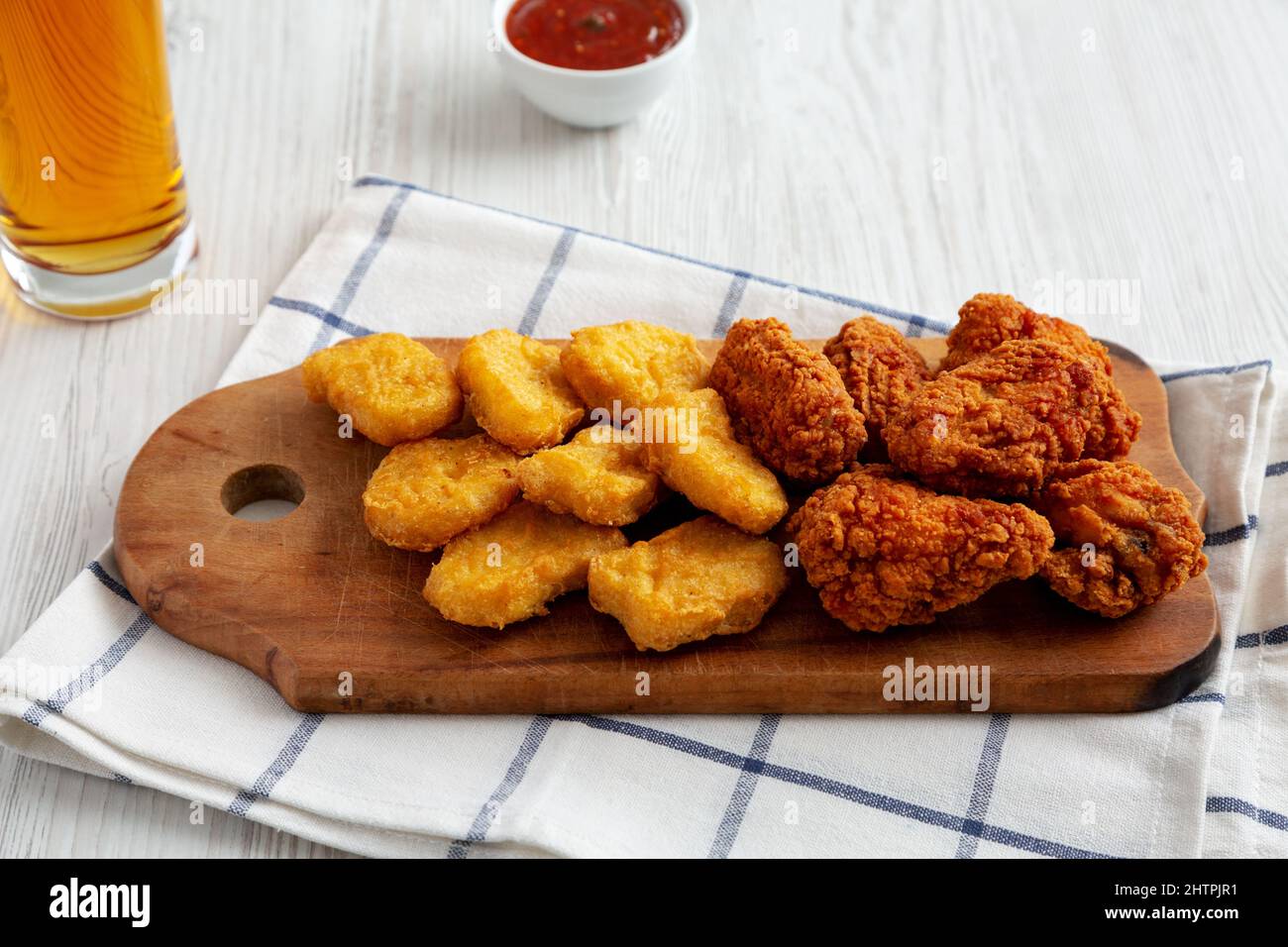 Homemade Crispy Fried Chicken Wings and Nuggets on a rustic wooden