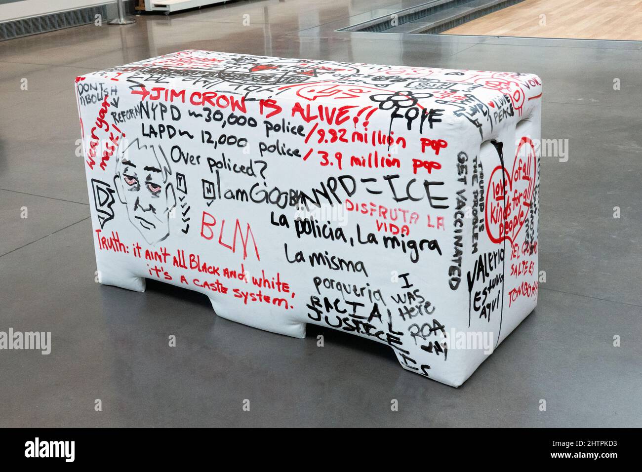 The rear of a plywood and foam imitation of an NYPD police barrier that viewers are invited to write on. At the Queens Museum in New York City. Stock Photo