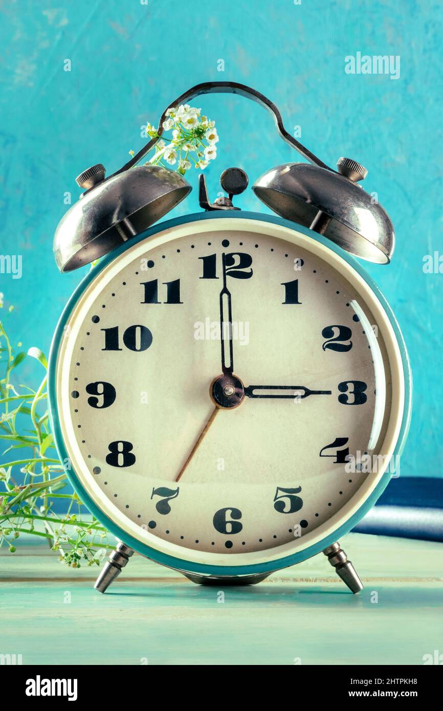 Daylight Savings Time concept, spring forward. An alarm clock with