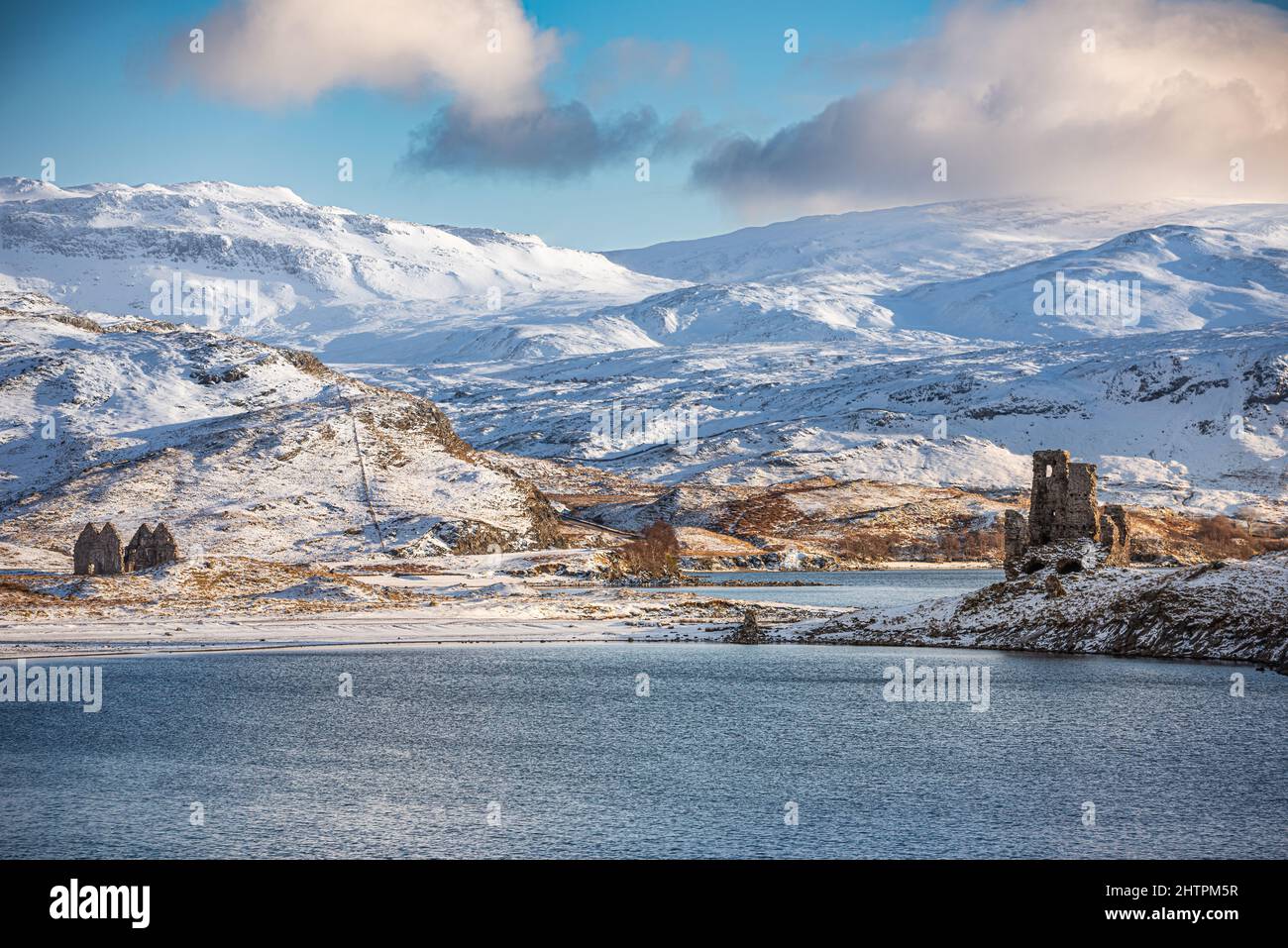 Ardvreck Castle in the snow, overlooking Loch Assynt & Calda House, Assynt, Highland, Scotland Stock Photo