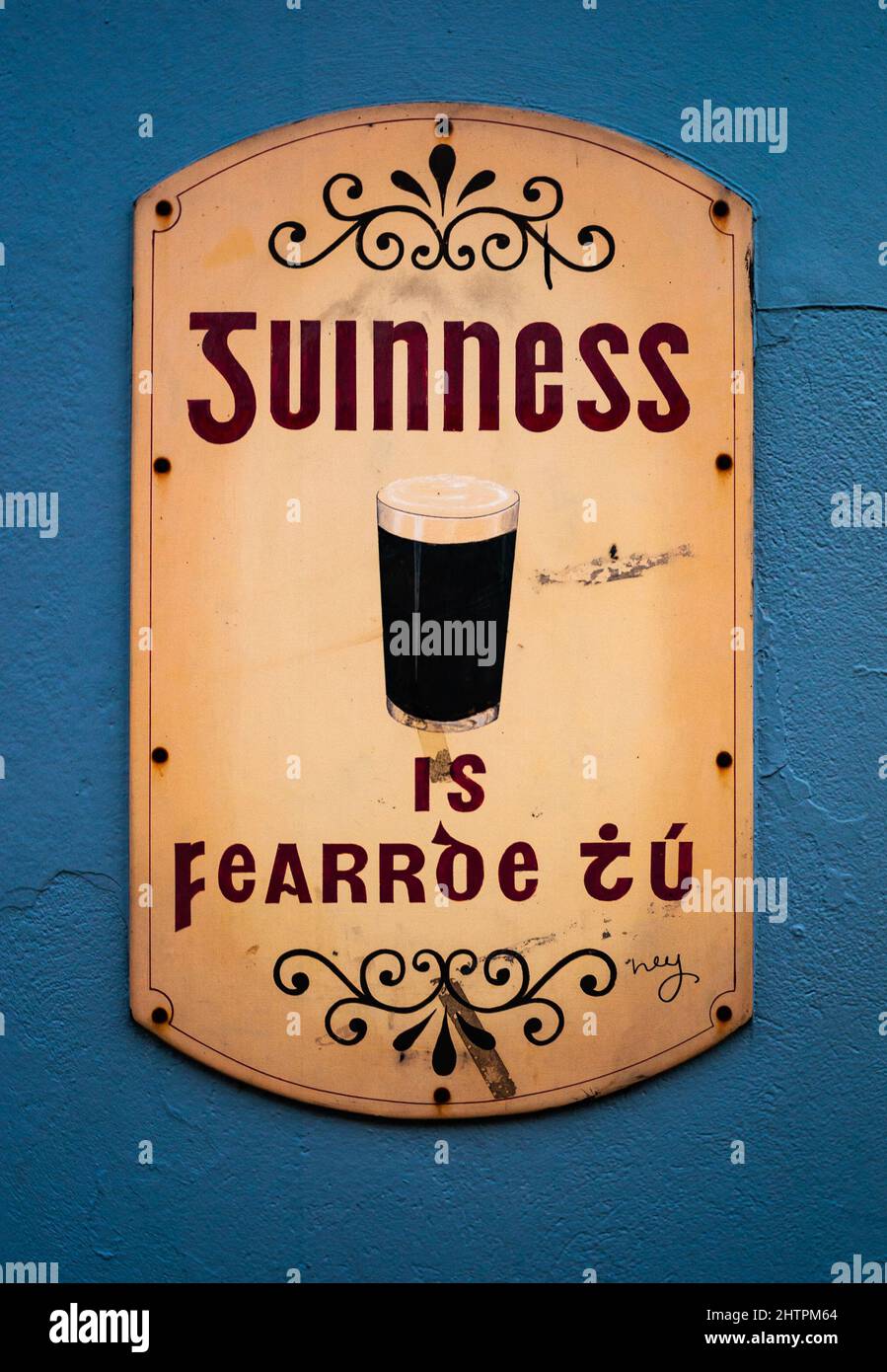 Close up on old vintage Guinness sign outside a bar in downtown Killarney Stock Photo