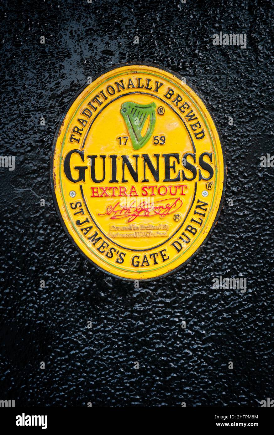 Close up on old vintage Guinness sign outside a bar in downtown Killarney Stock Photo