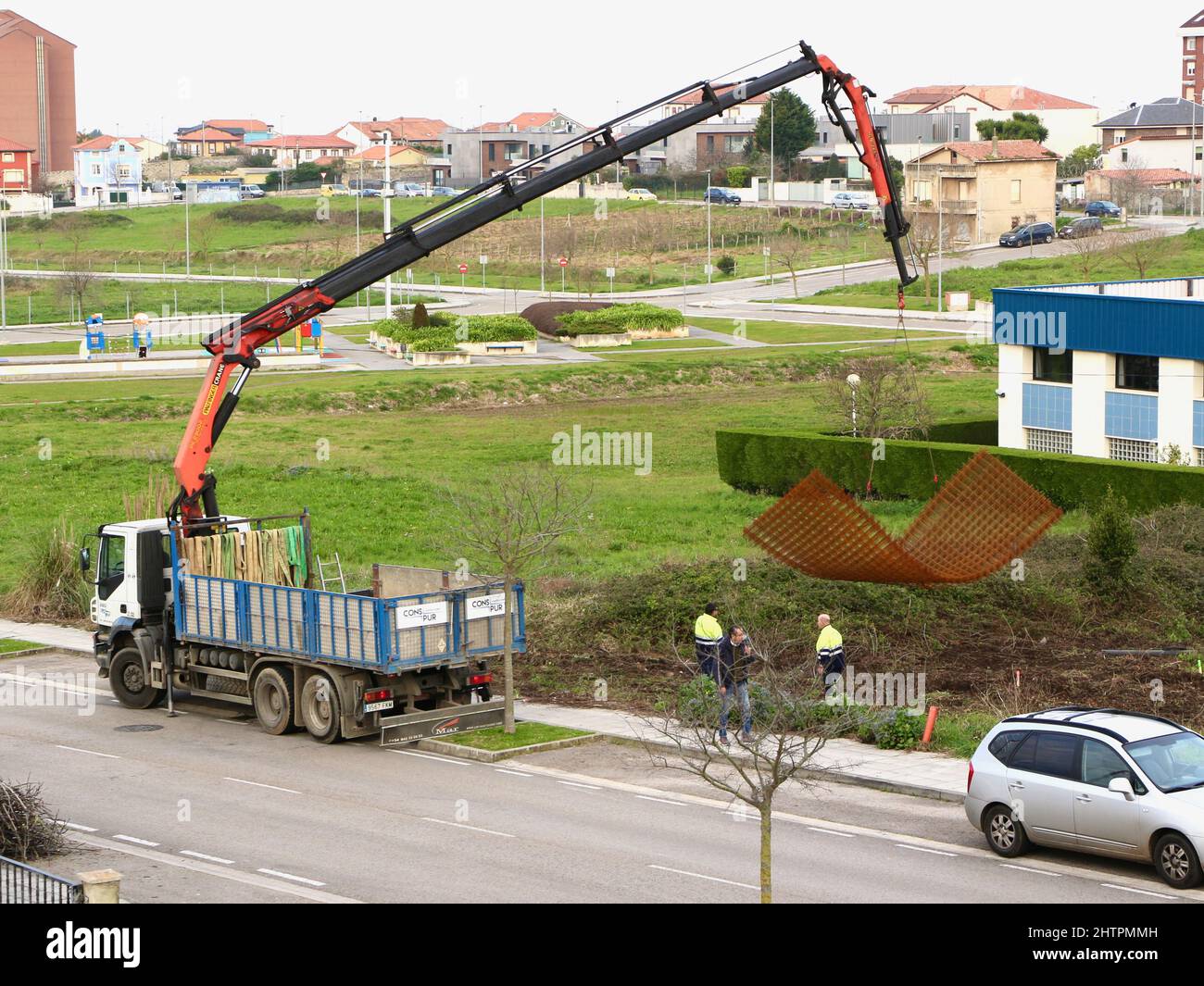 A remote control lorry mounted crane lowering rusty metal flexible