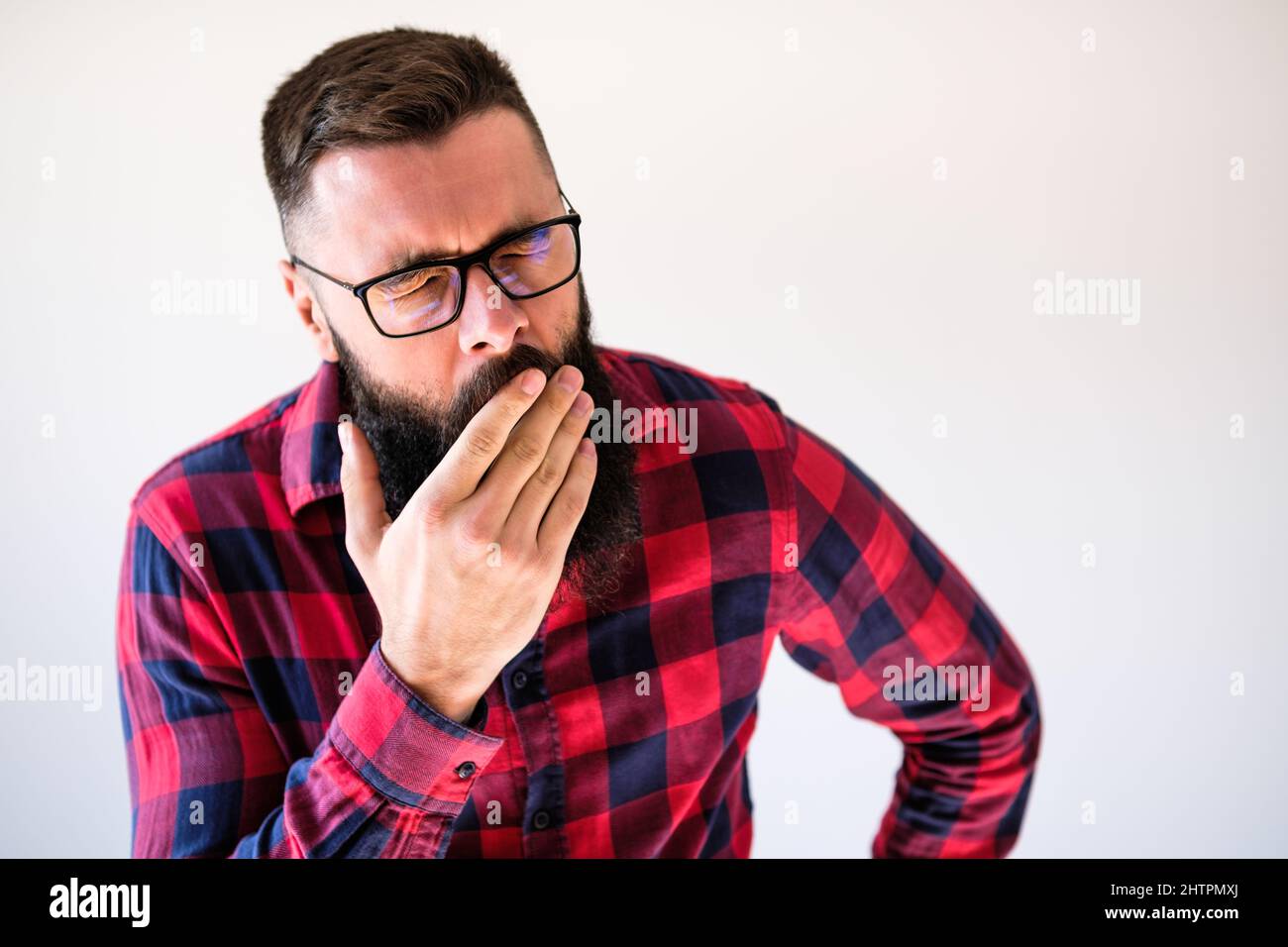 Portrait of man who is tired and yawning. Copy space on image for your text or advert. Stock Photo