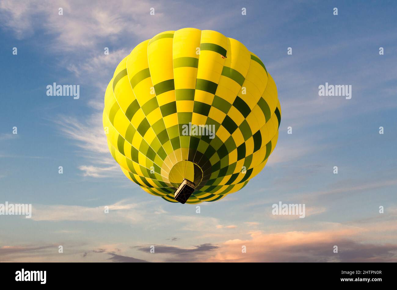Colorful hot air balloon flying over blue sky Stock Photo - Alamy