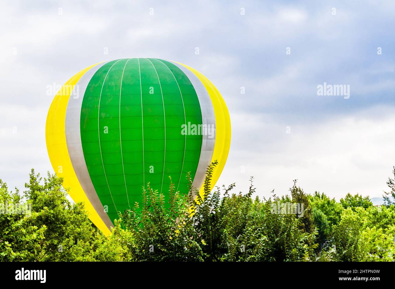 Colorful hot air balloon flying over blue sky Stock Photo - Alamy