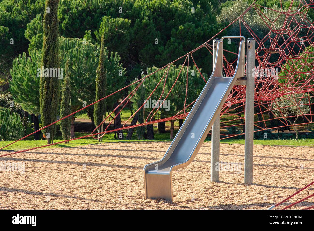 Metal children's slide on empty playground in the park Stock Photo