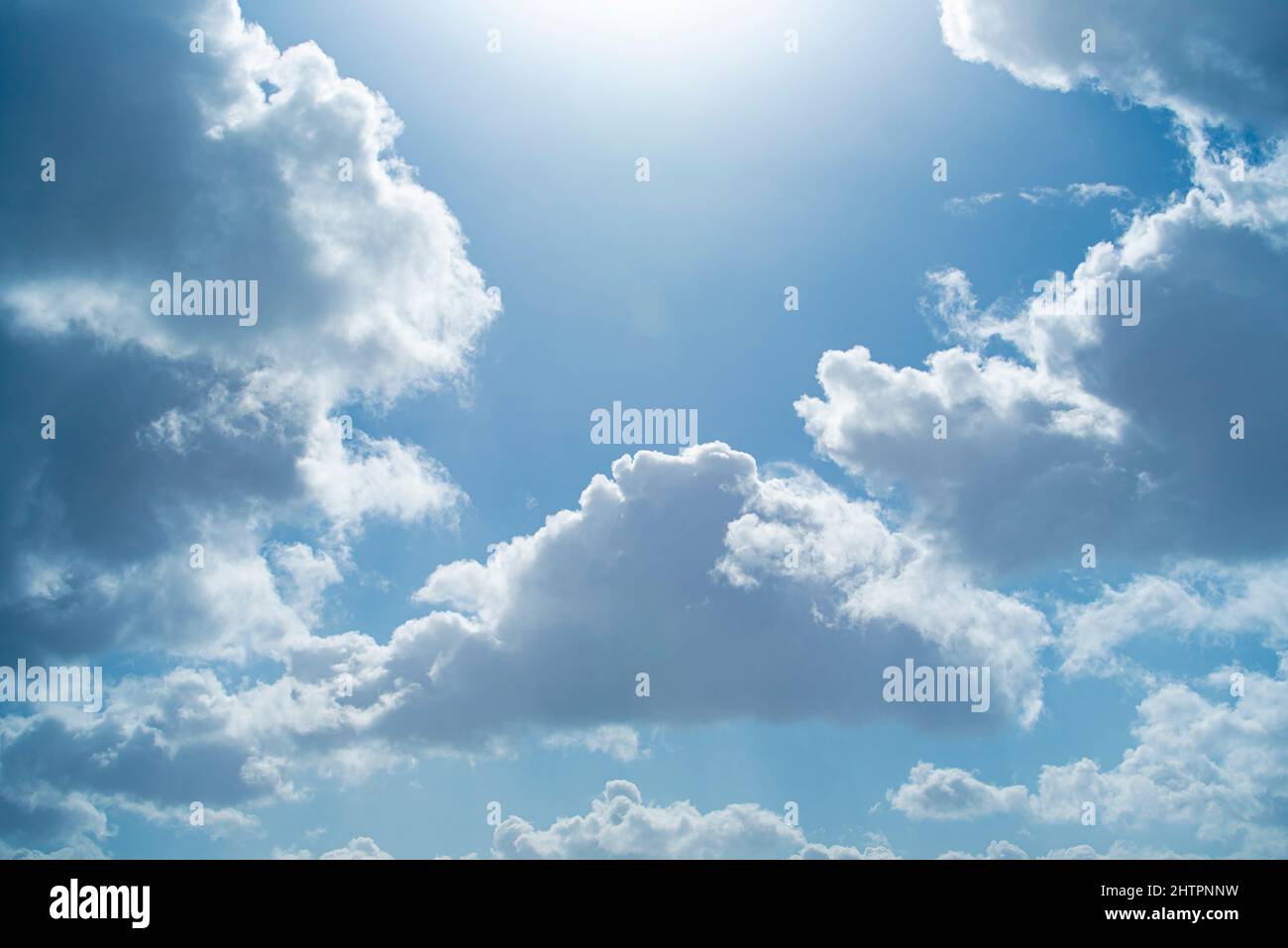 Blue sky with beautiful clouds and shining sun Stock Photo - Alamy