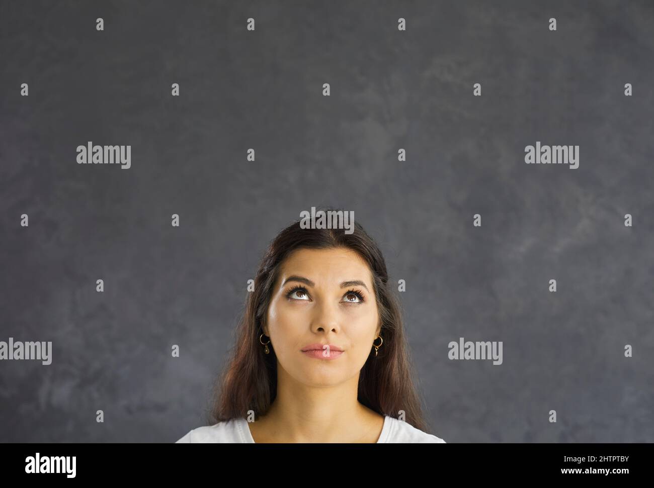 Young woman look at blank copy space thinking Stock Photo