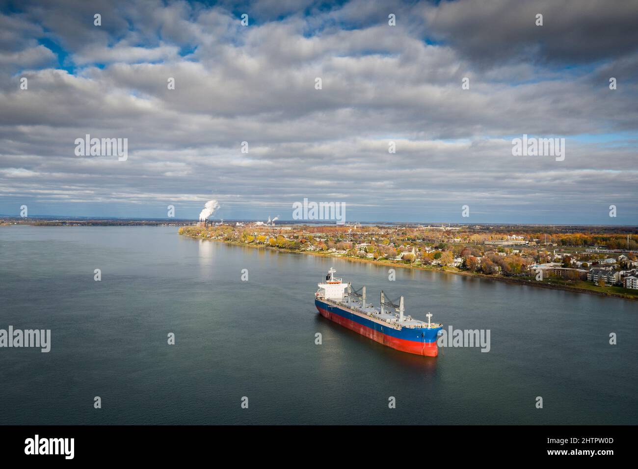Cargo ship, bulk carrier, anchored near the Port of Montreal on the St. Lawrence River. Stock Photo