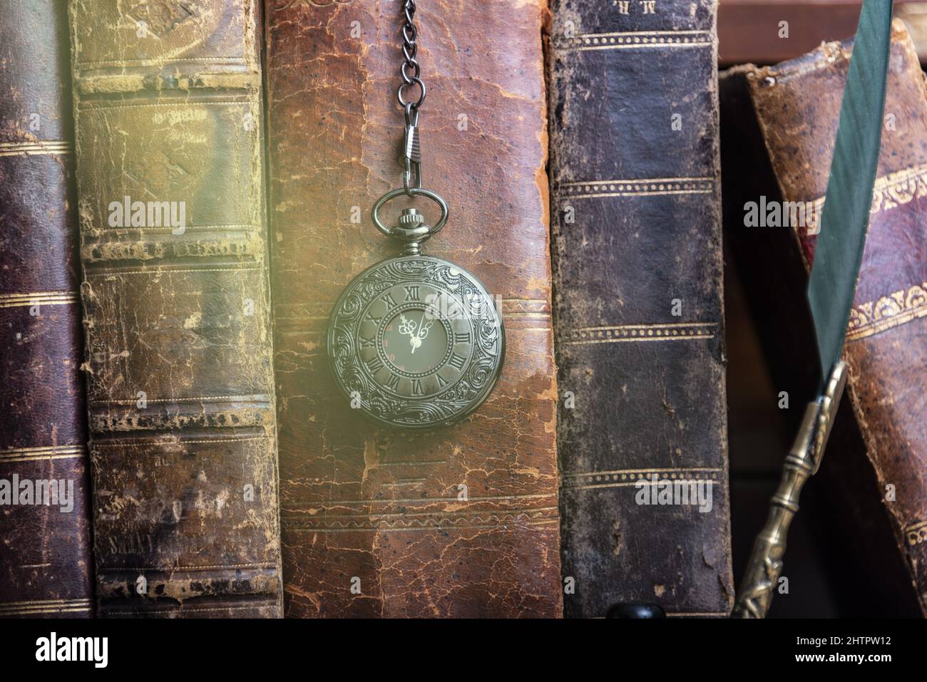 Classic still life with vintage books placed with old clock on rustic ...