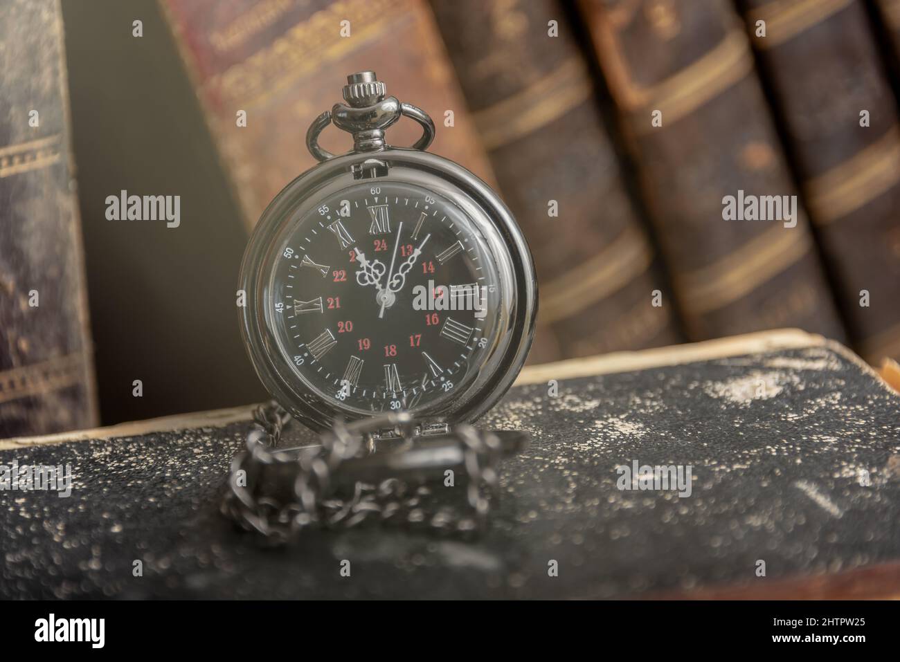 Classic still life with vintage books placed with old clock on rustic ...