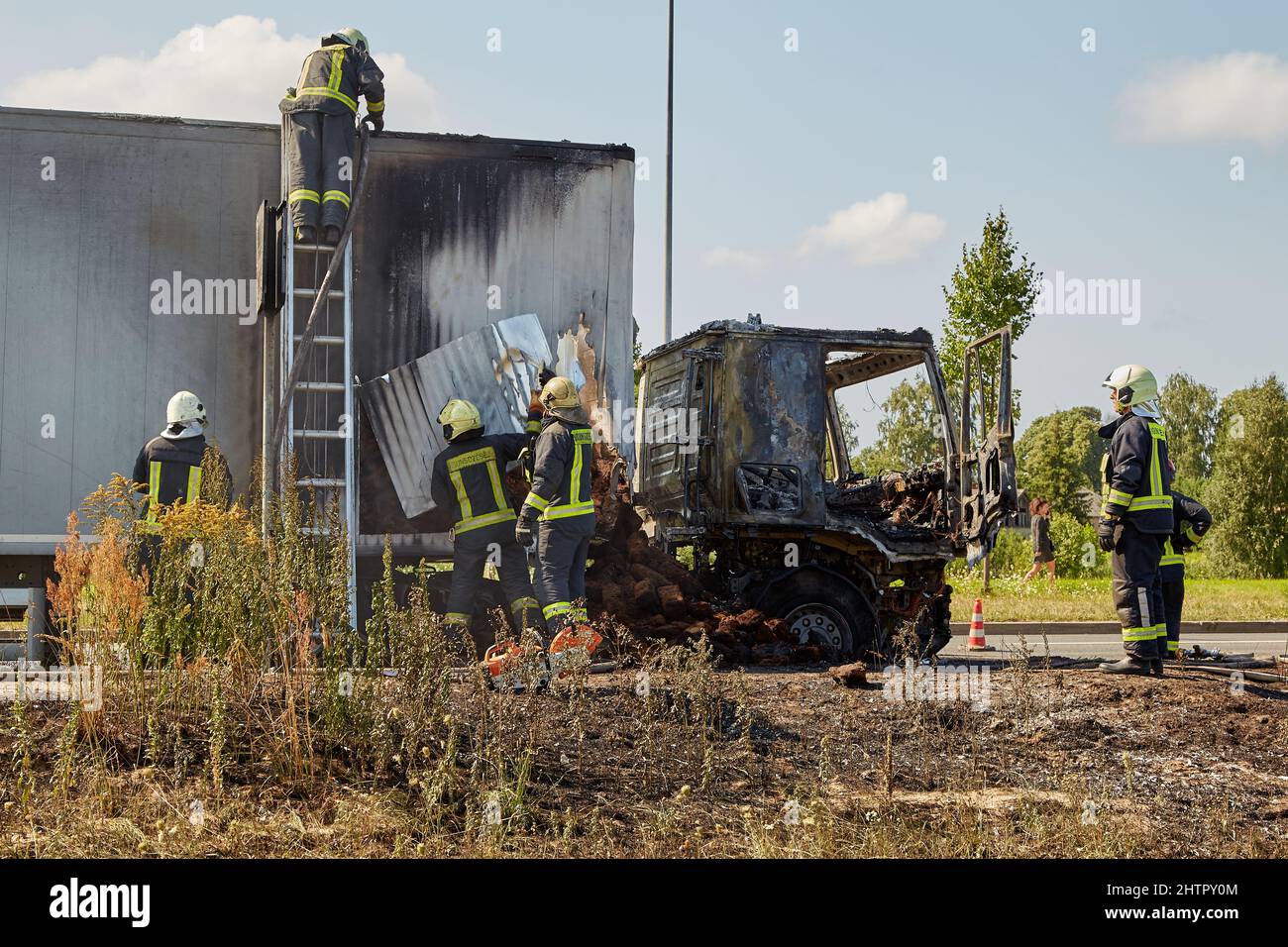 July 23, 2021, Riga, Latvia: firefighters extinguishing a burning car ...