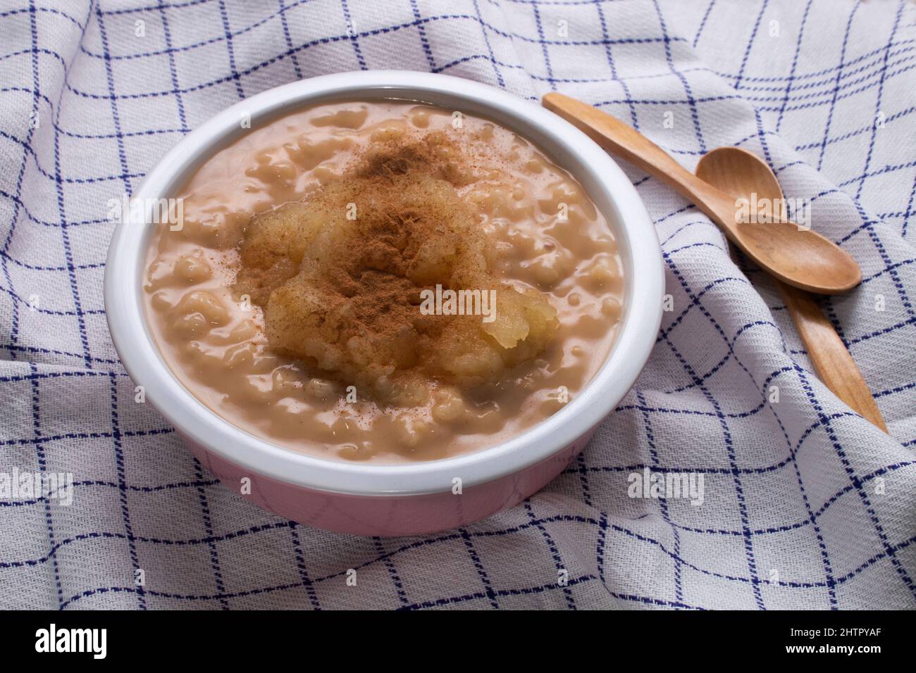rice pudding with apple compote and cinnamon in a bowl Stock Photo