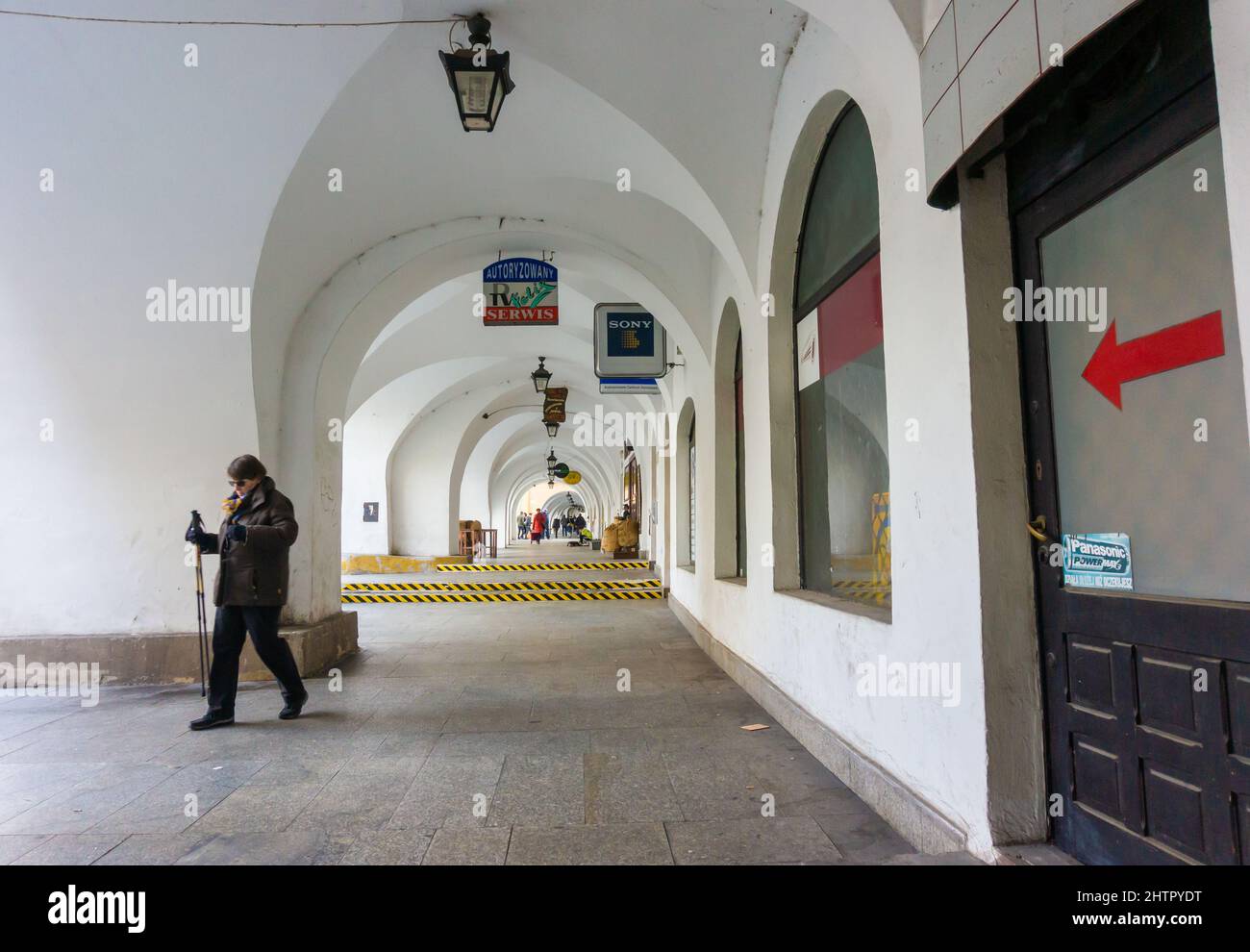 White building pillars and small shops in the old city center of