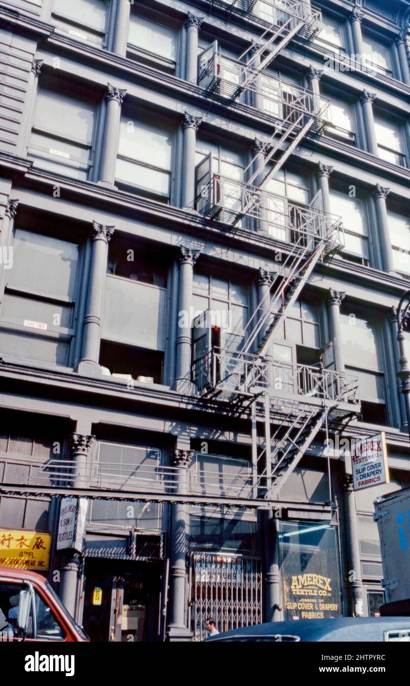 A 1980 view of 446-448 Broadway, New York City, USA showing the building’s fire escape ladder system. The five-storey building is located between Grand Street and Howard Street. It was designed by John Butler Snook in the 1870s and is an example of New York cast iron architecture. This image is from an old Kodak colour transparency taken by an amateur photographer – a vintage 1980s photograph. Stock Photo