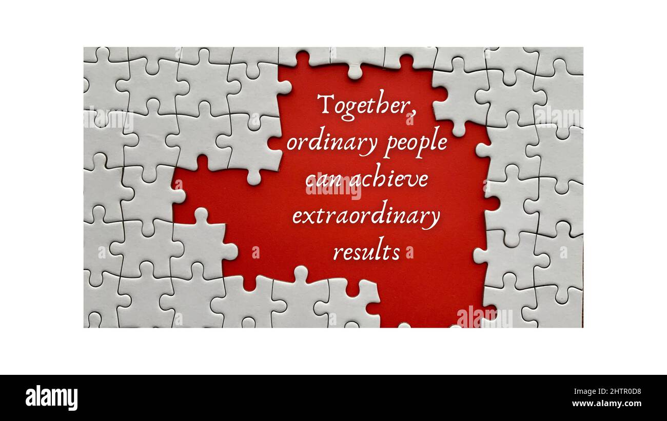 Top view of motivational quote on red cover - Together, ordinary people can achieve extraordinary results.With jigsaw puzzle missing pieces background Stock Photo