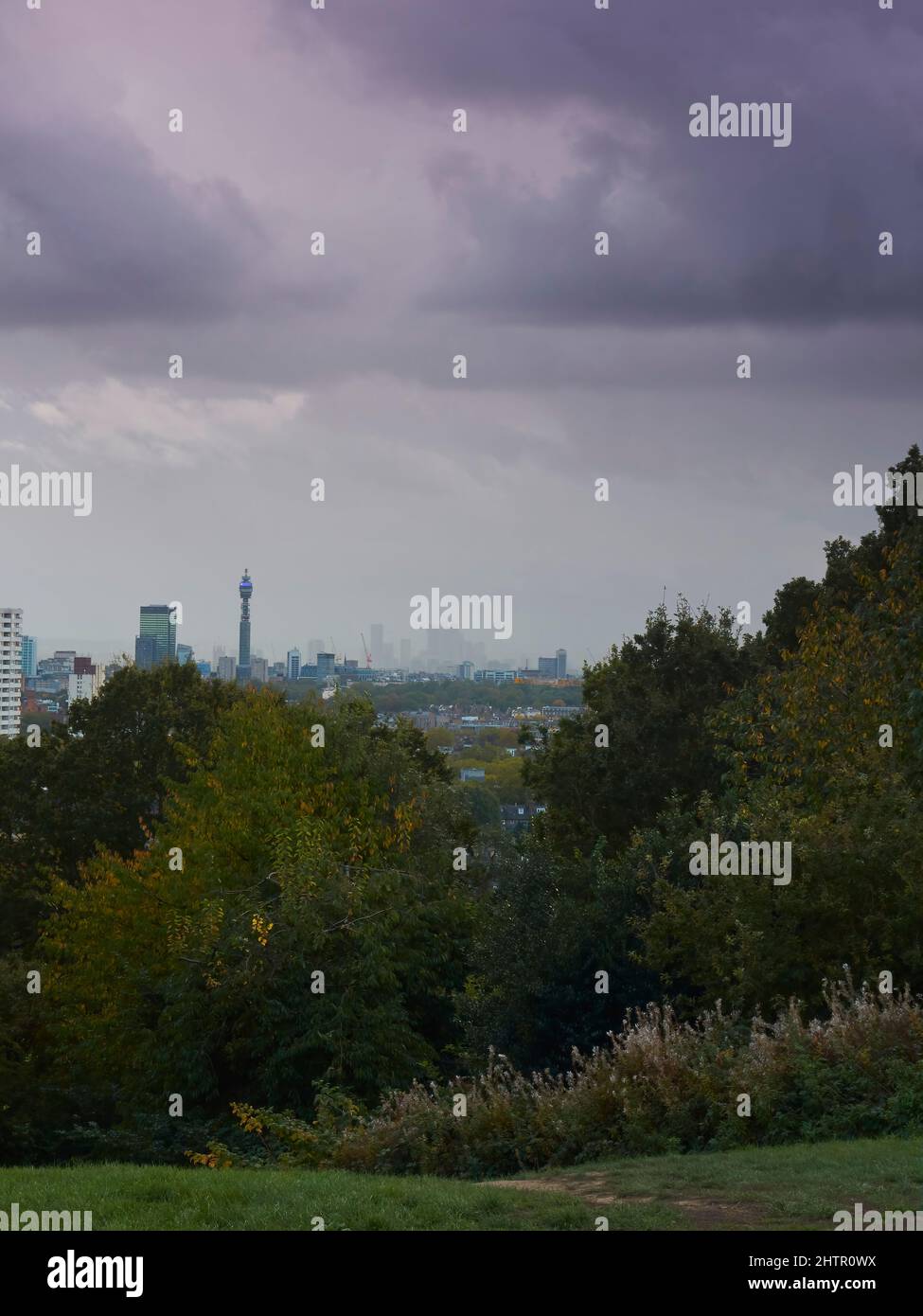 A London skyline from Parliament Hill Fields, with the buildings pressed under a heavy, leaden sky of near impenetrable layer of clouds. Stock Photo