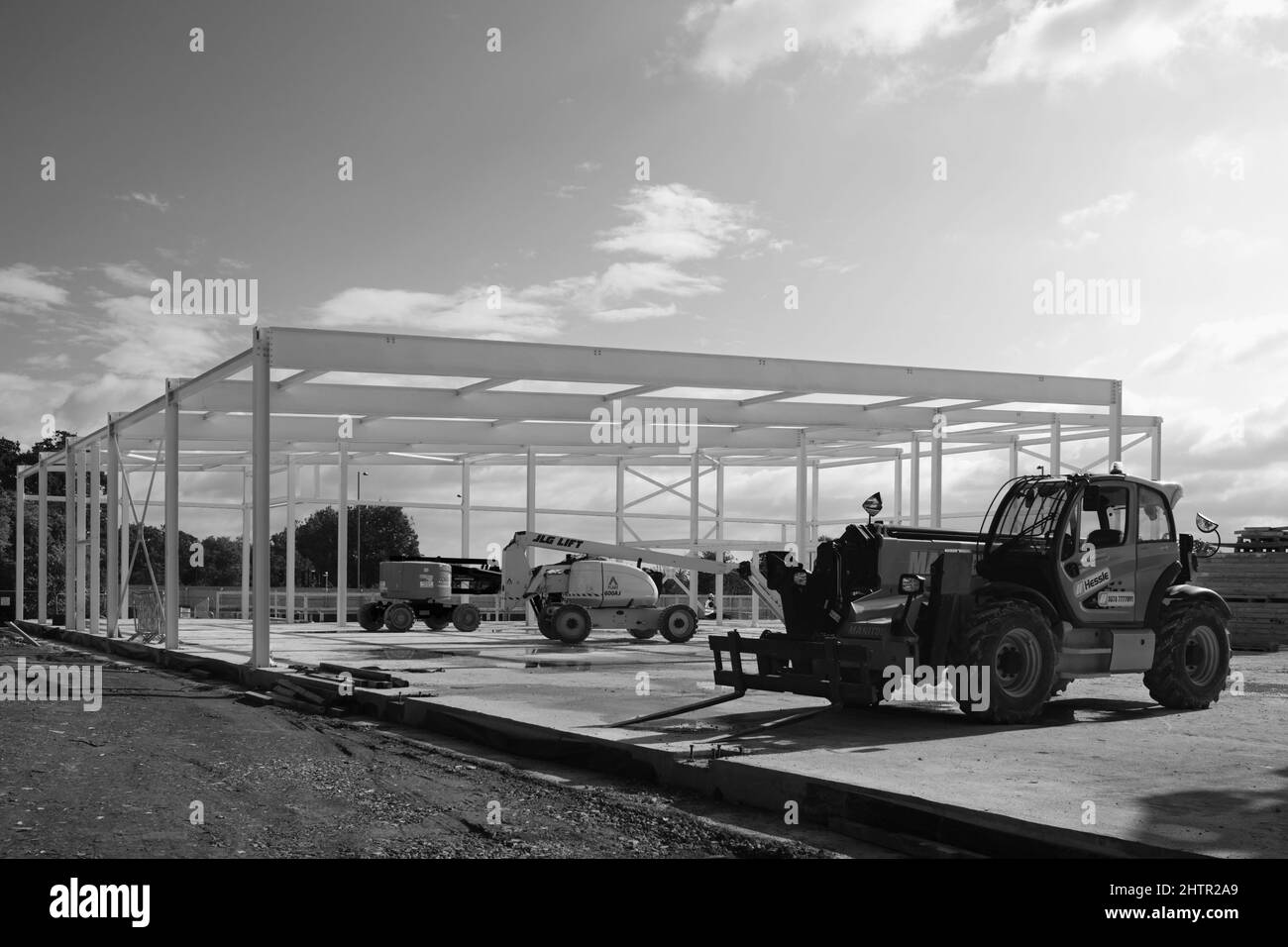 Modern supermarket being constructed by usig steel framework using large machinery on fine day in Beverley, UK. Stock Photo