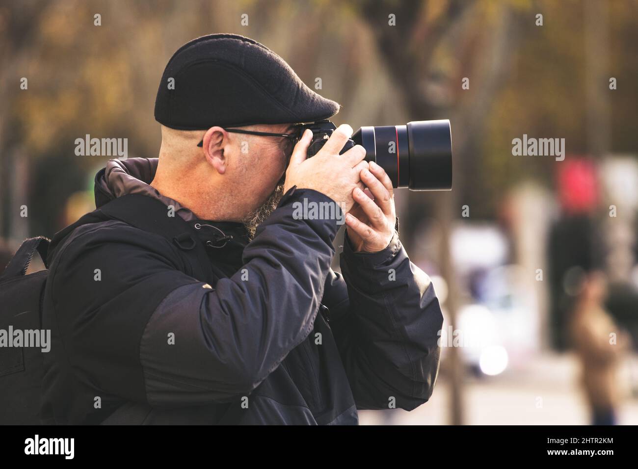 Beautiful shot of a Caucasian man photographing something with a camera Stock Photo