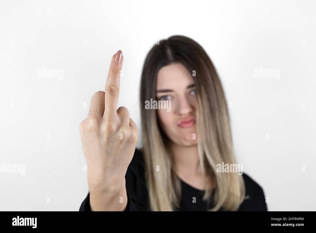 Fuck you hand sign. Bad girl gesture. Provocative and rude gesture