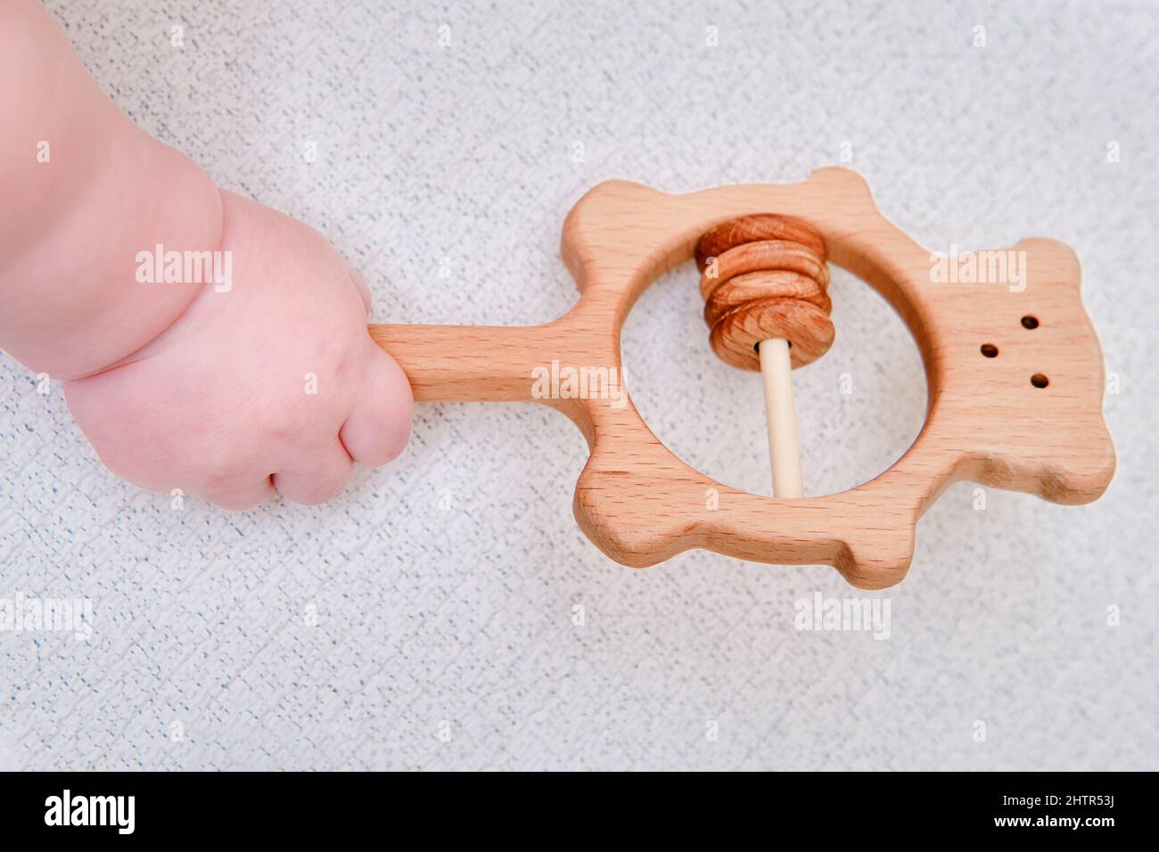 Baby hand and toy rattle abacus, close-up. Children fingers and an ...