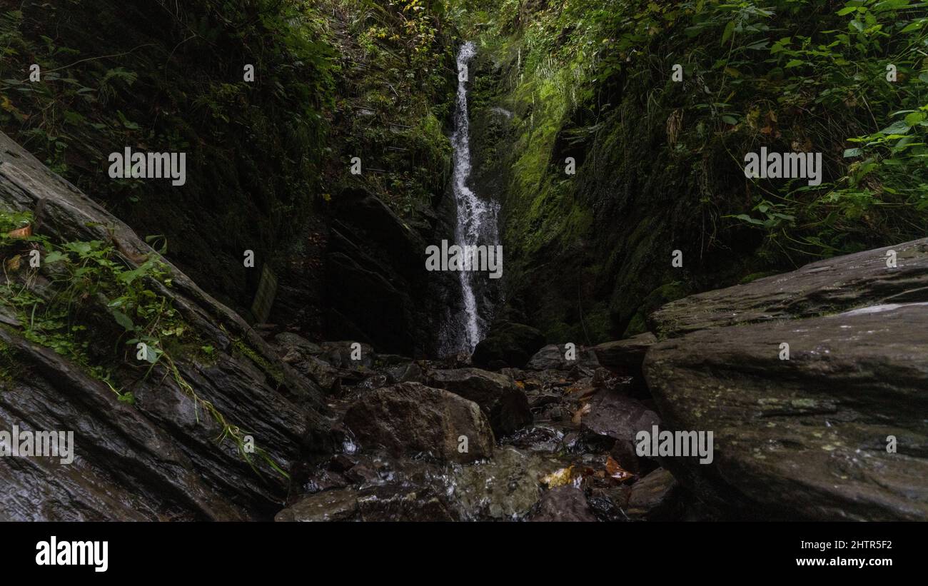 View of a picturesque gorge with narrow water stream flowing into it ...