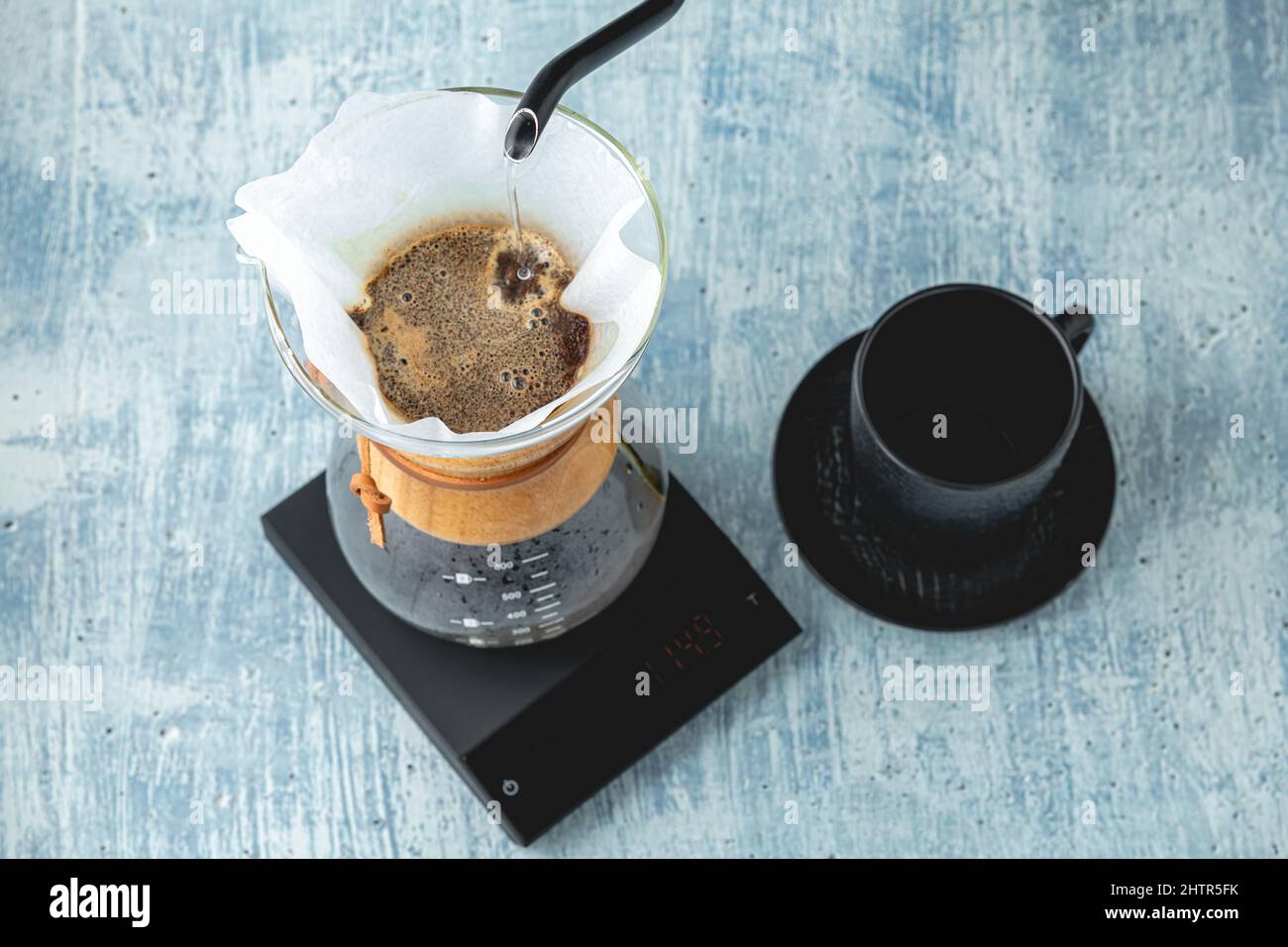 Professional barista brews coffee using chemex. Alternative ways to brew coffee. Coffee shop concept. Stock Photo