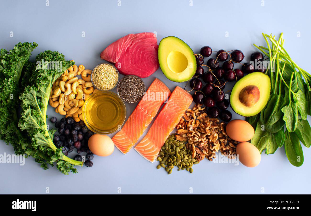 Overhead View of Fresh Omega-3 Rich Foods: A variety of healthy foods like fish, nuts, seeds, fruit, vegetables, and oil rich in omega-3 nutrients Stock Photo