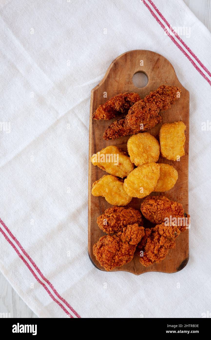 Tasty Fastfood Chicken Nuggets, Wings and Tenders on a rustic wooden