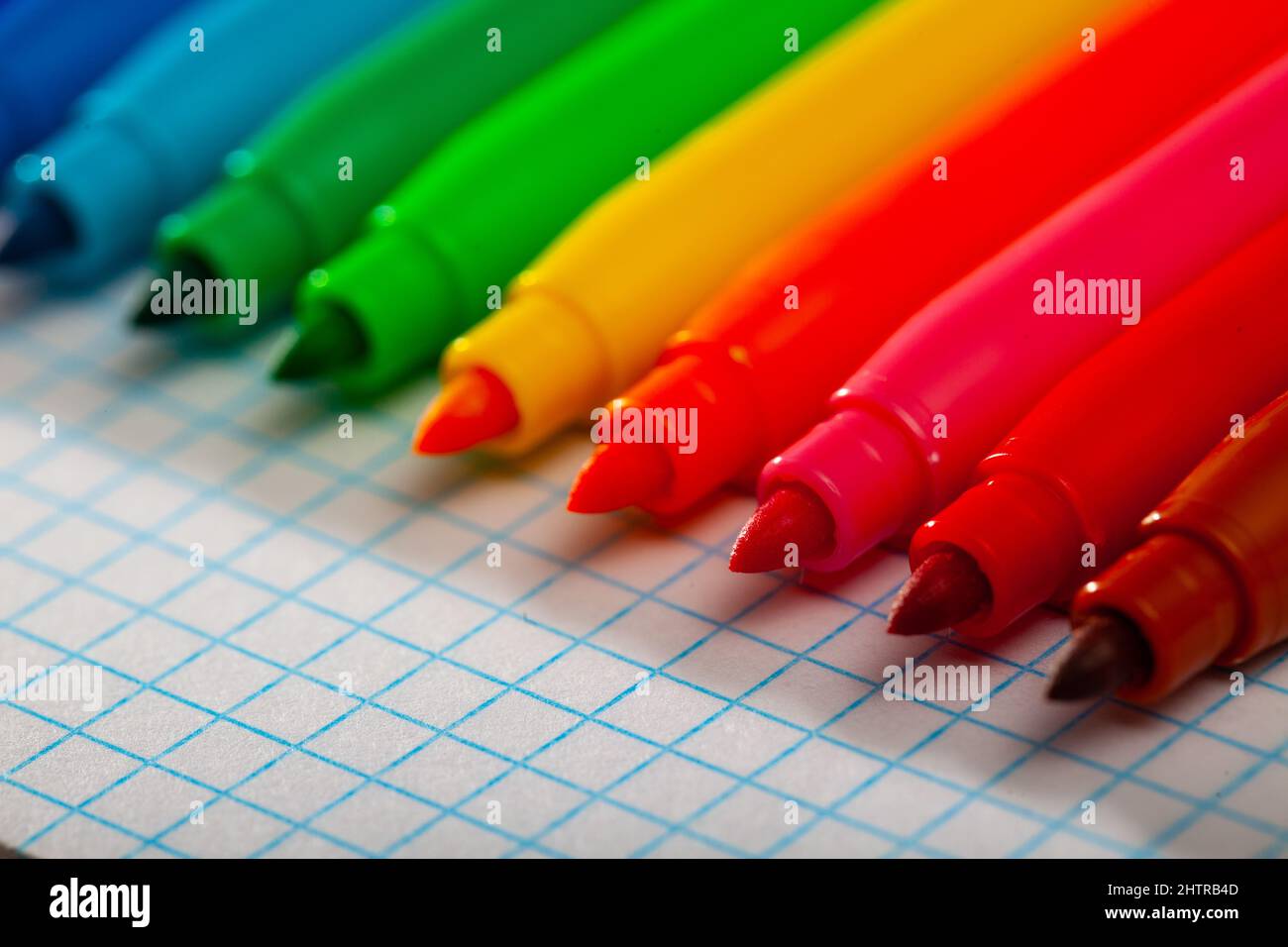 Image of opened multicolored markers on notepad Stock Photo