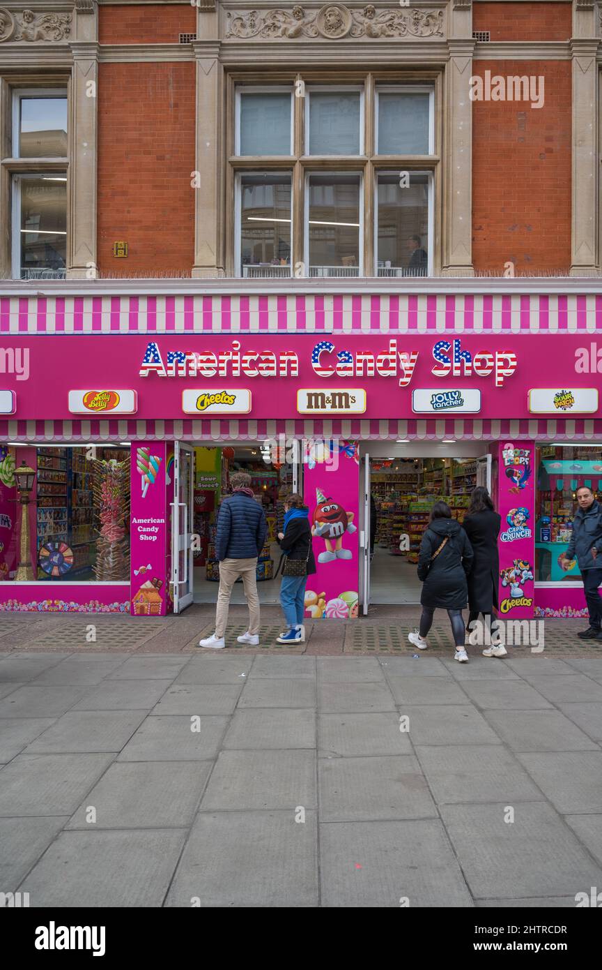 People walk by outside the American Candy Shop, Oxford Street, London, England, UK. Stock Photo