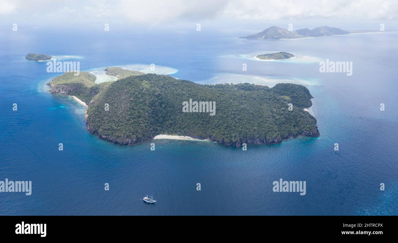 Healthy coral reefs surround a remote island in Indonesia's Banda Sea ...