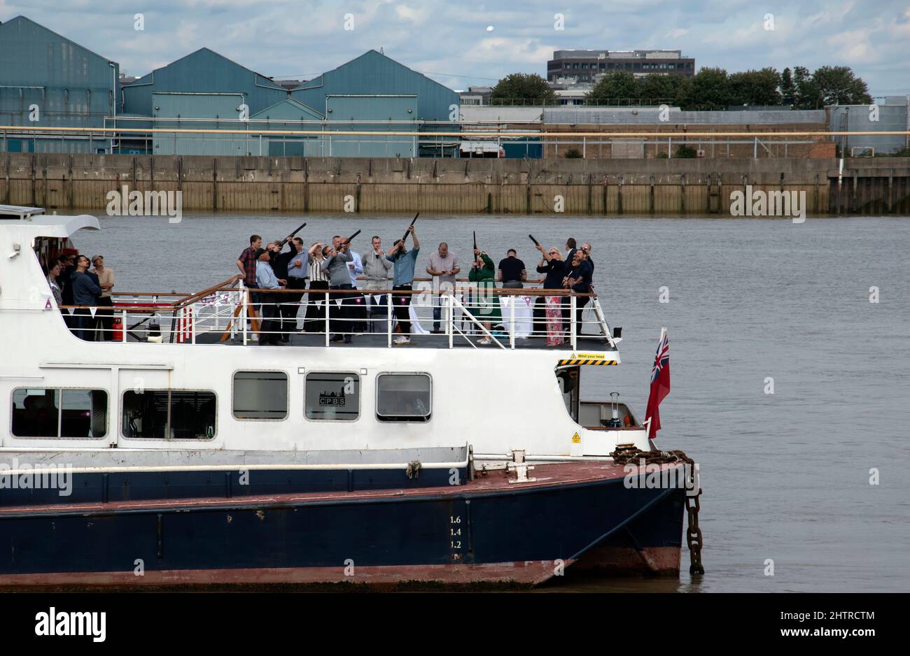 London, UK - September 17th 2021: People shooting clay pigeons on a boat on river Thames Stock Photo