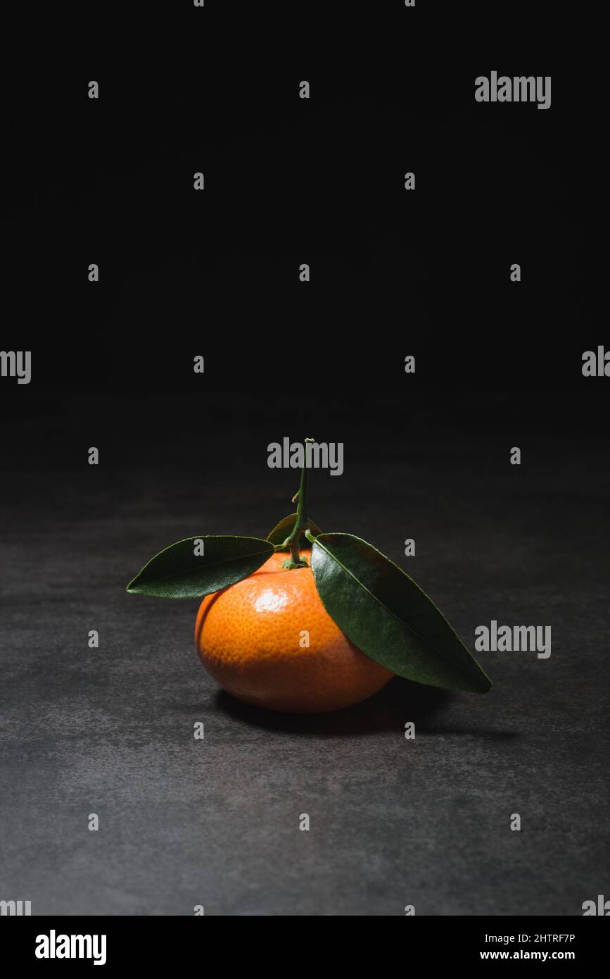 Fresh mandarin with leaves on dark background Stock Photo