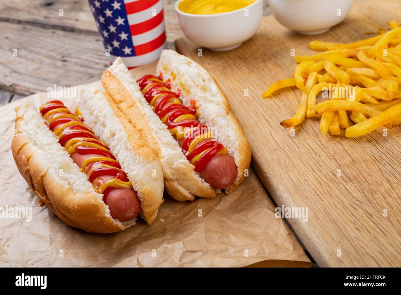 Hot dogs with tomato and mustered sauce served with french fries and