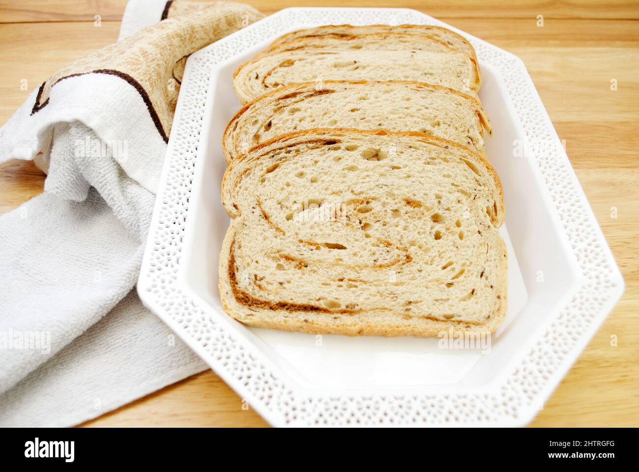Rye & Pumpernickel Swirled Loaf of Bread on a White Platter Stock Photo
