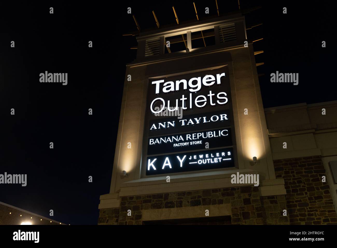 Southaven, Mississippi - January 12, 2022: Sign for Tanger Outlets, an outdoor discount shopping mall, at night Stock Photo