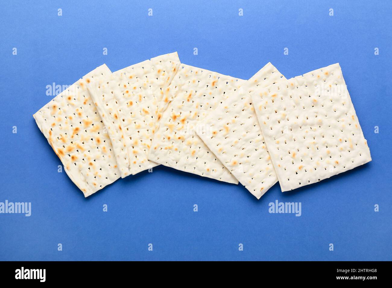 Jewish flatbread matza for Passover on blue background Stock Photo Alamy