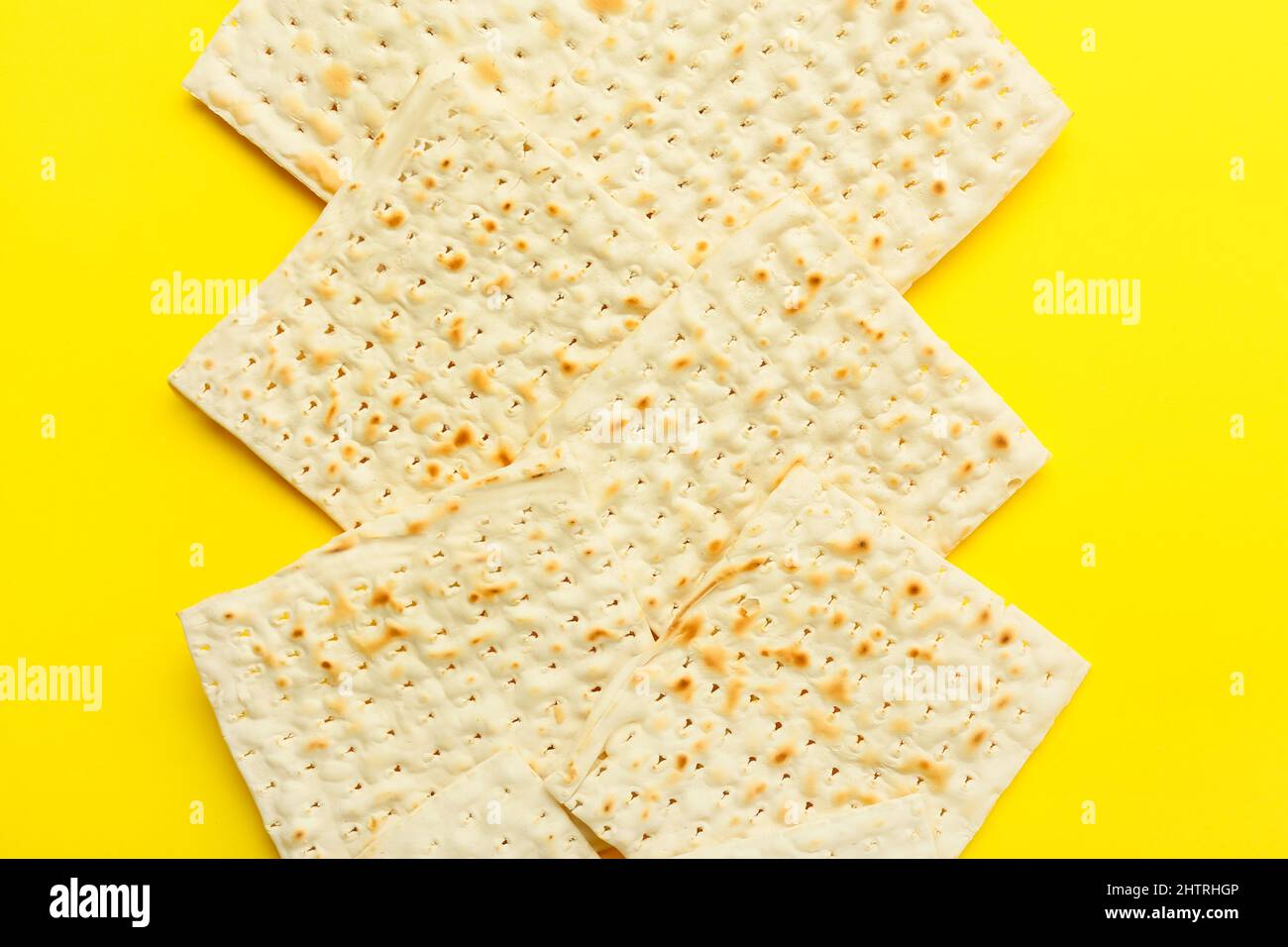 Jewish flatbread matza for Passover on yellow background Stock Photo