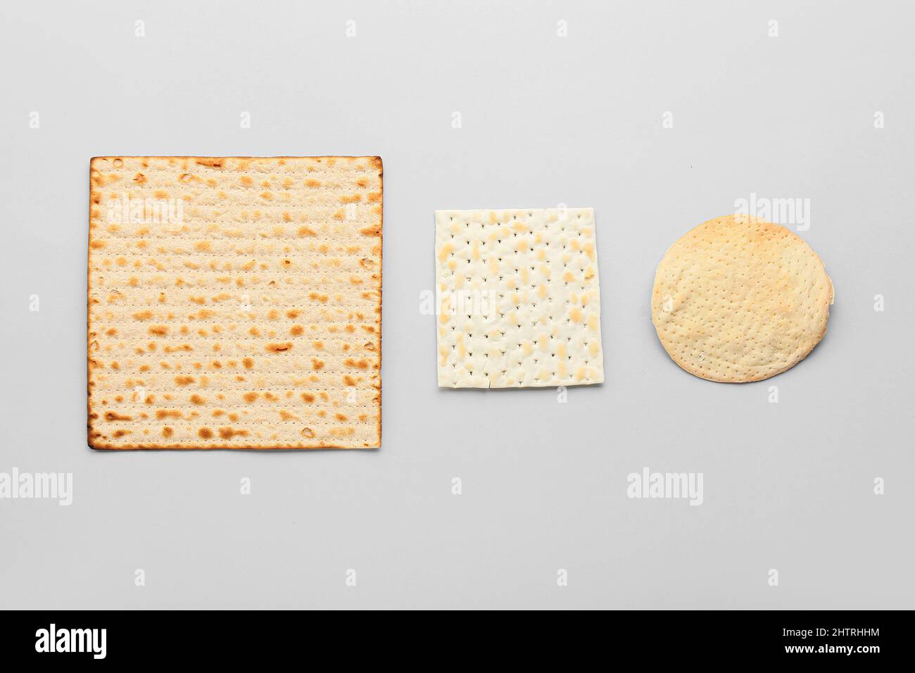 Different Jewish flatbread matza for Passover on light background Stock