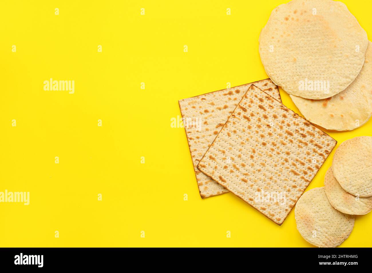 Different Jewish flatbread matza for Passover on yellow background
